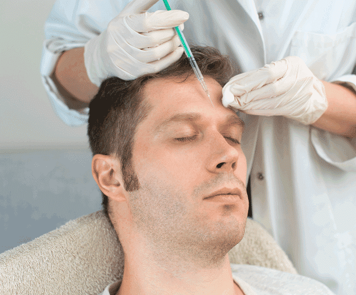 A man getting injected with facial Botox. 