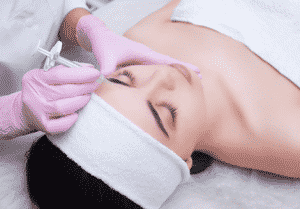 Woman getting a Botox treatment done.